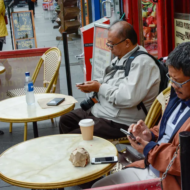 People Sitting While On Their Mobiles — photograph 24 of 25