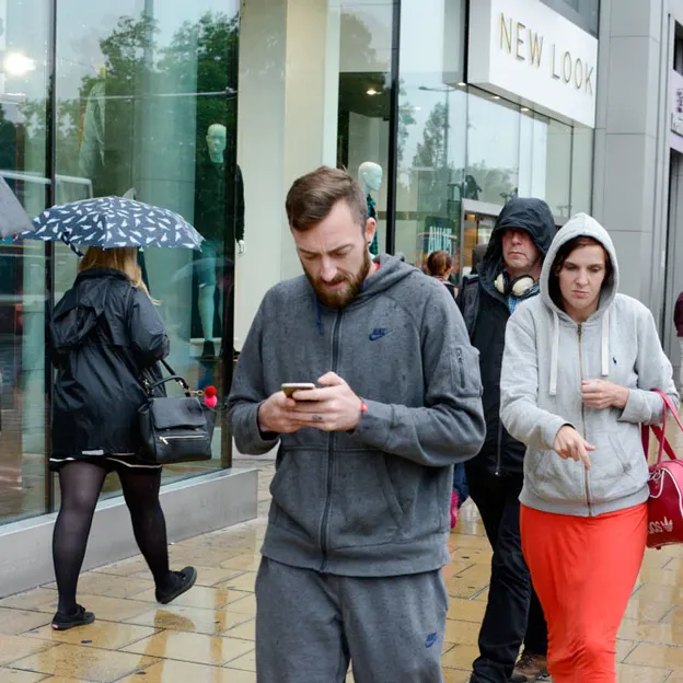 People Walking While On Their Mobiles — photograph 17 of 28