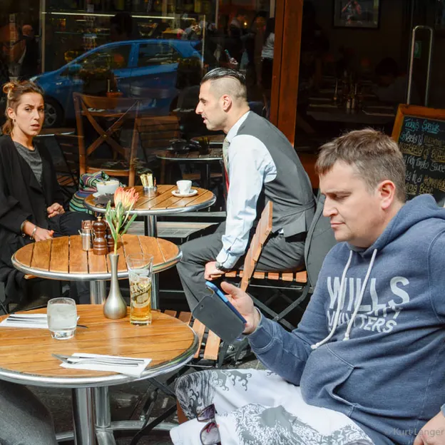 People Sitting While On Their Mobiles — photograph 10 of 25